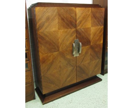 SIDE CABINET, Art Deco, palissandre the stepped top over a pair of figured doors enclosing shelves with decorative nickle han