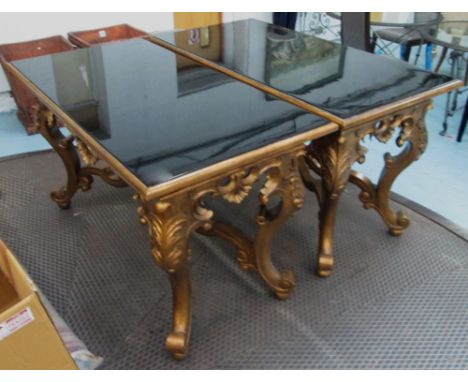 CHRISTOPHER GUY CONSOLE TABLES, a pair, large rectangular black lacquer tops on ornately carved Continental style giltwood sc