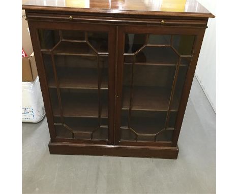 Bookcase with glass front and hidden shelf