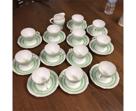 12 cups and saucers plus milk jug, green and white