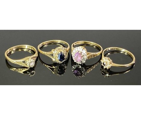 9CT GOLD DRESS RINGS (4) - one having ribbed shoulders to a coronet mount with central pink claw set stone and a half diamond