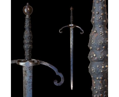 A German two handed sword with high quality forged blade, 16th-19th century. Beautiful forged guard with two rings on both si