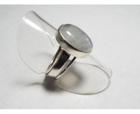 A lady's silver dress ring set with an opalescent centre stone, size M + ½
