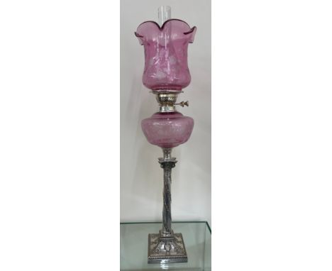 Silver plated column base walker and hall oil lamp with cranberry glass shade total height approximately 32 inches 