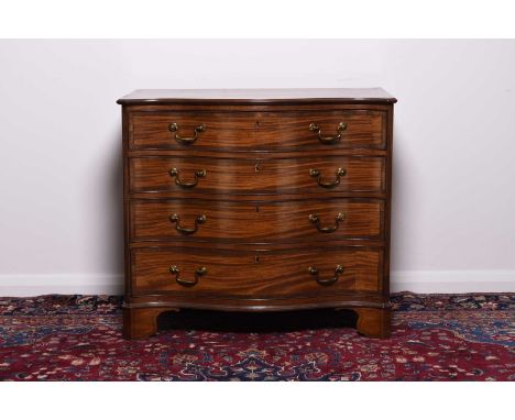 A George III mahogany serpentine fronted dressing chest The moulded top with cross banding and chevron stringing, above four 