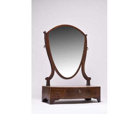 A 19th century mahogany toilet mirrorThe shield form plate on scroll supports above a bow fronted cross-banded and boxwood st