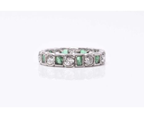 An emerald and diamond eternity ring, designed as alternating old cut diamonds and rectangular cut emeralds milligrain set in