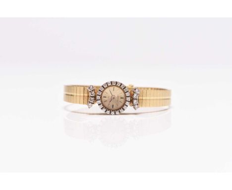 Omega: A lady's 18ct gold diamond set bracelet watch Date: Circa 1970 Movement: Jewelled manual wind Dial: Gold brushed, appl