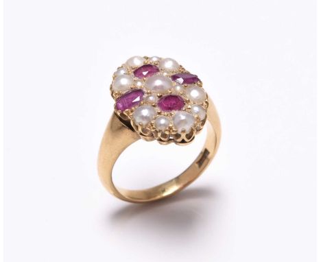 A late 19th century untested split pearl and ruby set ring, the lozenge shape panel set with four oval mixed cut rubies and f