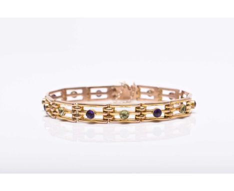An early 20th century peridot and amethyst set bracelet, each yellow metal three bar gate link set with alternating single ro