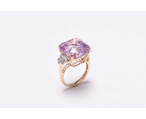 An 18ct gold kunzite and diamond ring, designed as a central emerald cut kunzite within four claw mount set between decorativ