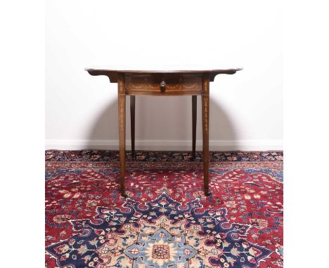 A Regency inlaid mahogany Pembroke tableThe oval moulded top with satinwood cross-banding, inlaid with a band of meandering f