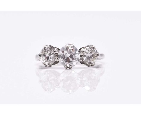 A graduated three stone diamond ring, the brilliant cut diamonds claw set in white metal to white metal shank, ring size O, s