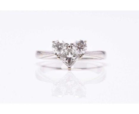A three stone heart shaped diamond ring, the two brilliant cut diamonds and single square faceted diamond claw set in white m
