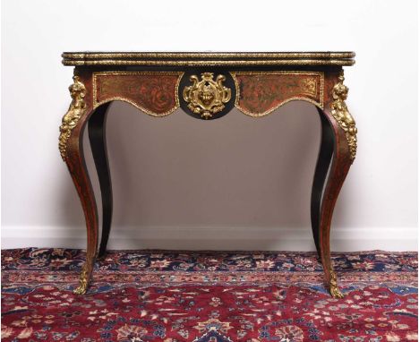 A French ebonised, red tortoiseshell, inlaid cut brass and gilt metal mounted 'Boulle' card tableLate 19th/early 20th century