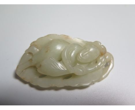 A Carved Jade Pendant in the form of a standing lady and reverse carved as foliage 
