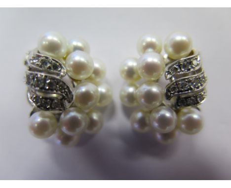 A Pair of Pearl and Diamond Earrings on 14K white 