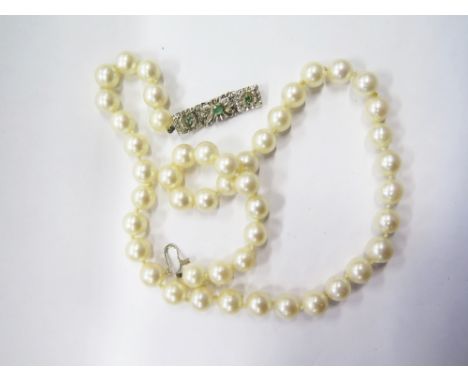 An Pearl Necklace with 18ct white gold and emerald set clasp 