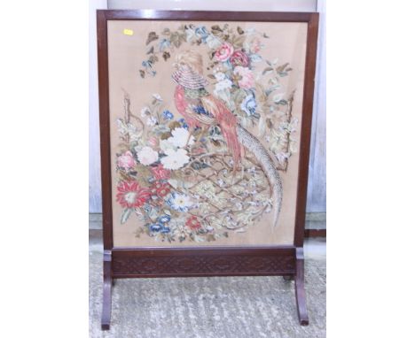 An early 20th century needlework fire screen, in walnut frame, 25" wide