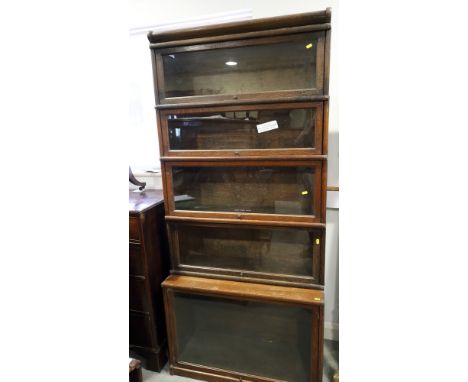 An oak Globe Wernicke five-section bookcase with lift up glazed doors, 34" wide