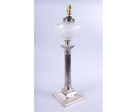 A plated Corinthian column table lamp with cut glass reservoir, 22" high (now converted to electricity)