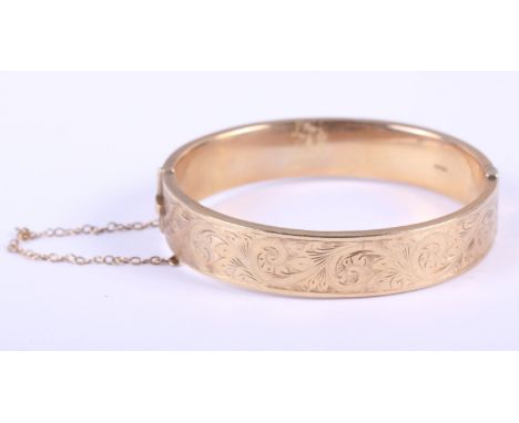 A 9ct gold engraved bangle, 18.7g