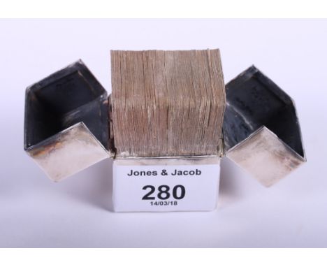 A silver miniature playing card box containing two decks of playing cards