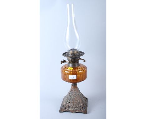 An amber cut glass reservoir oil lamp cast iron stand, 14" high