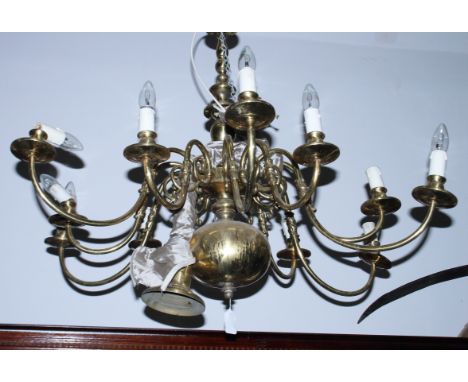A Dutch design twelve-branch brass centre light fitting with scroll arms, 36" dia, and a similar, smaller, light fitting, 30"