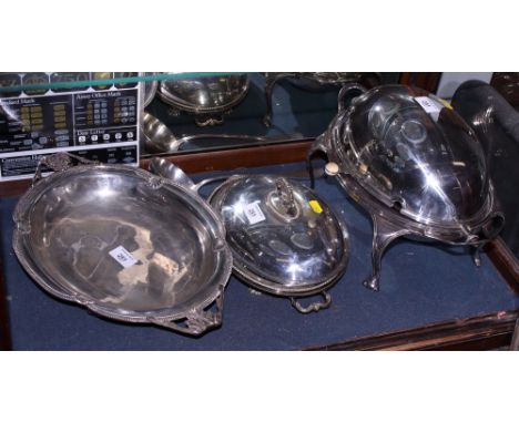 A silver plated breakfast warmer, a plated two-handled dish, a plated entree dish and cover and a plated ladle