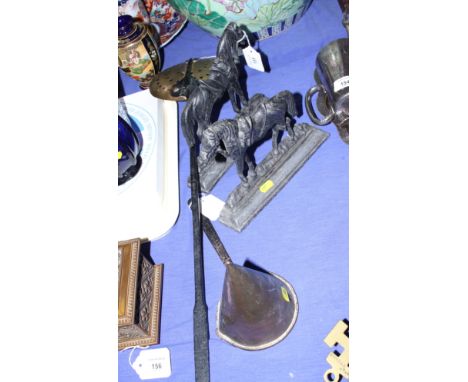 A pair of 19th century cast iron horse door stops, 9 1/2" wide, a brass cream skimmer and a copper conical ladle