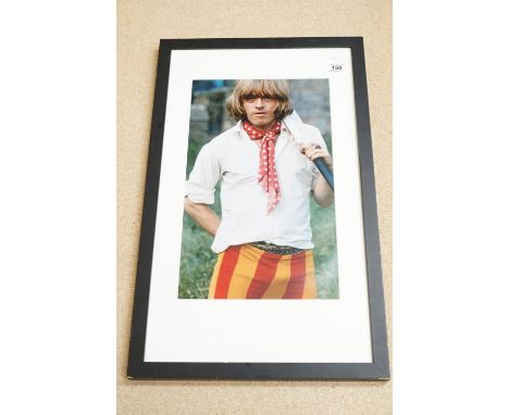 Music Memorabilia - The Rolling Stones Brian Jones photograph holding cricket bat, well presented in frame and mount 