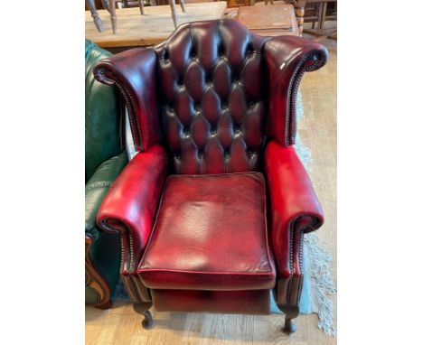 A button back winged recliner armchair, burgundy leather upholstered on cabriole legs, H105, W80cm.