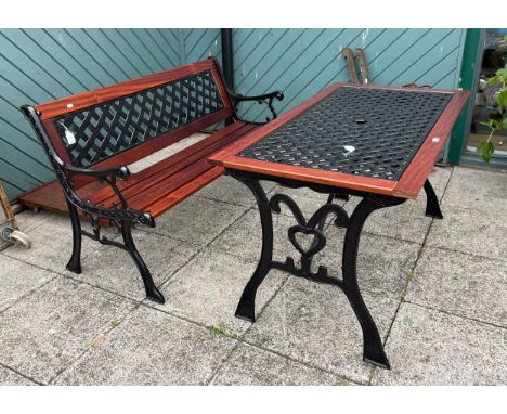 A cast iron garden seat/bench, having slatted hardwood seat and backrest, 127cm long, together with a matching rectangular ga