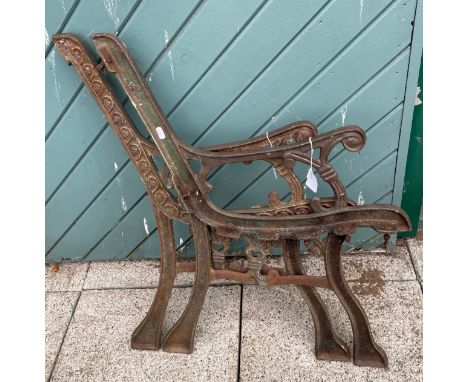A pair of cast iron garden bench ends.