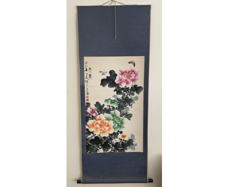 A Chinese scroll painting, signed upper left, with ink character marks and red seal marks, depicting butterflies amongst foli