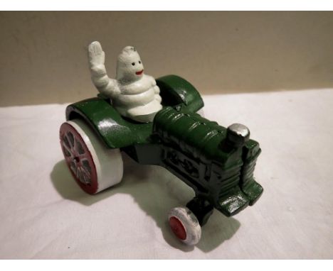 Cast iron Michelin man on tractor. H: 80mm UK P&amp;P Group 1 (£16+VAT for the first lot and £2+VAT for subsequent lots) 