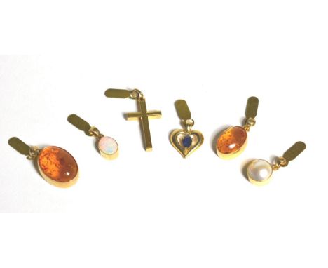 An opal pendant, a mabe pearl pendant, a sapphire pendant, a cross pendant and two amber pendants