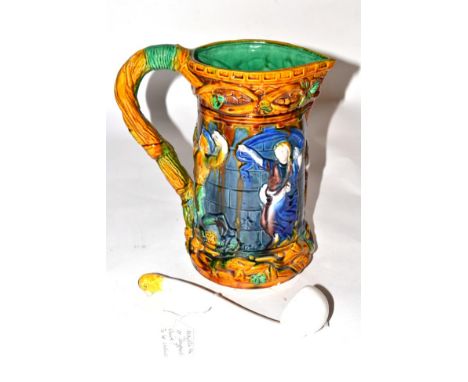 A Majolica jug, figural design; with a Victorian ladle (2)