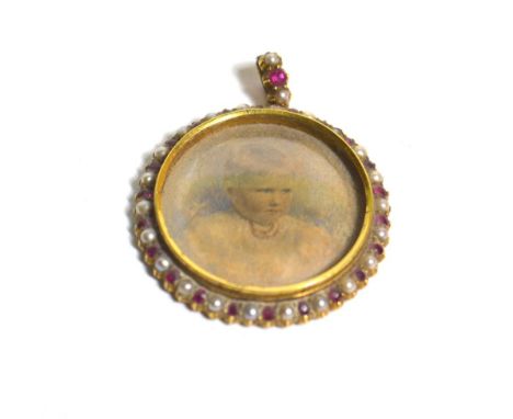 An Edwardian 18 carat gold ruby and pearl child portrait pendant 