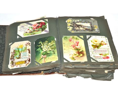 An early 20th Century postcard collection, various subjects including birthday; photographic; humorous etc, the album in poor