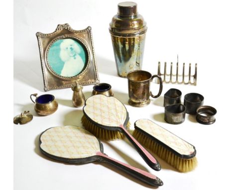 Assorted silver to include a photograph frame; an enamel part dressing table set; a toastrack etc together with a silver plat