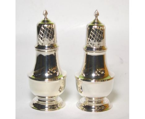 A pair of silver casters, K M Silver, Birmingham 1993, with pierced pull off cover, 16.5cm high, 8.8ozt