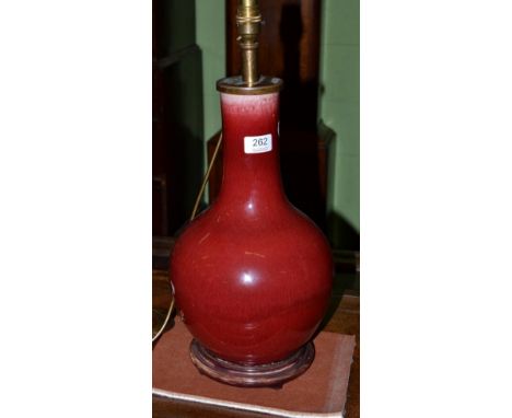 A Chinese sang de boeuf porcelain bottle vase table lamp