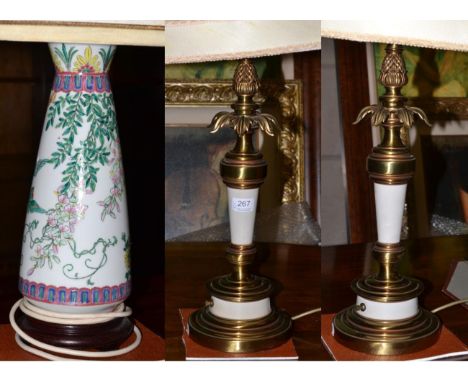 A pair of large gilt metal table lamps and a porcelain table lamp (3)