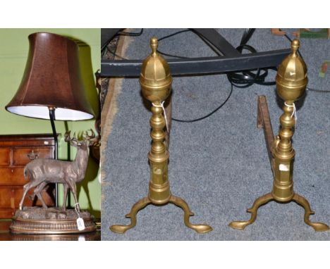 A bronzed metal lamp modelled as a stag and a pair of brass and steel andirons