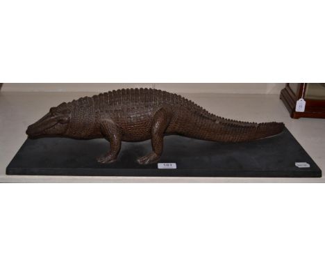 A resin model of a Crocodile in walking pose, mounted upon a slate base 