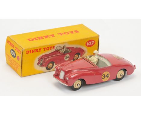 Dinky Toys 107 Sunbeam Alpine Sports - Cerise body, grey interior with figure, silver trim and light beige rigid hubs and rac