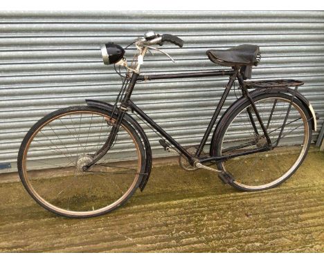 A gents bicycle with headlamp attached.