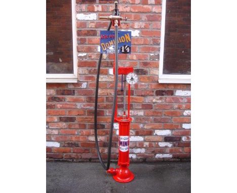 A Gilbert and Barker hand cranked petrol pump, restored in Dominion livery, complete with 1/4d brand plate mounted with a loo